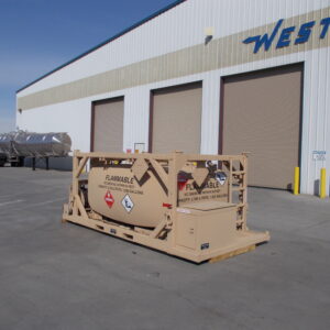 Industrial warehouse exterior with three large brown doors; a beige flammable liquid trailer in the foreground and a silver tanker nearby under a clear blue sky.